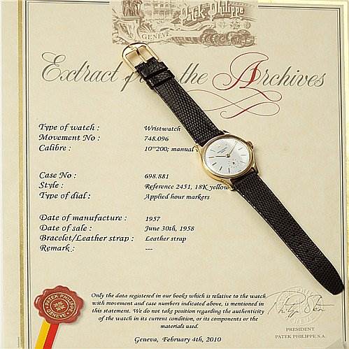 The image shows a Patek Philippe Vintage model wristwatch placed on an "Extract from the Archives" document, showing details about the watch.