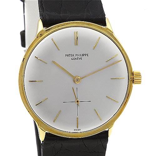 The image shows the front view of a vintage Patek Philippe watch, highlighting its gold case, white dial, and leather strap.