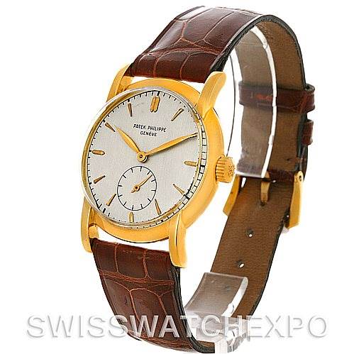 This image shows a Vintage Patek Philippe watch at an angled side view, highlighting its gold case, dial, and brown leather strap.