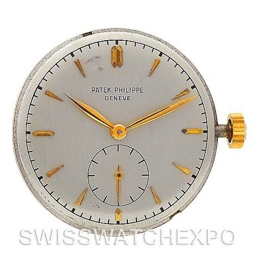 This image shows a front view of a Vintage Patek Philippe watch face with gold hands and markers, including the crown.
