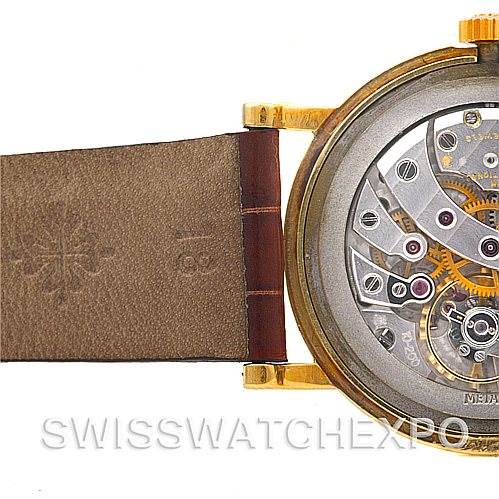 The image shows the back view of a Vintage Patek Philippe watch, highlighting the movement and leather strap.