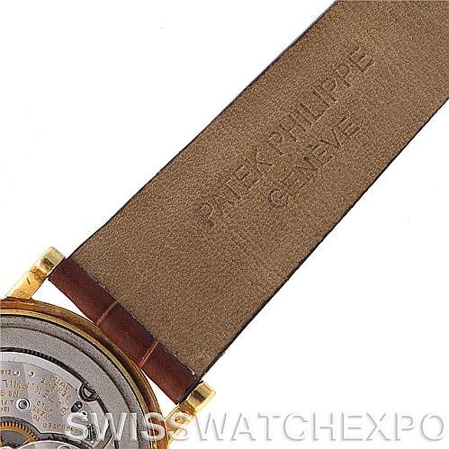 This image shows the back of a Vintage Patek Philippe watch, including the movement mechanism and a part of the leather strap.