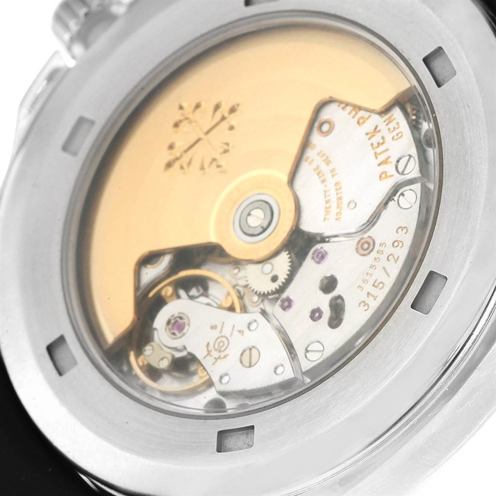 The image shows the back of a Patek Philippe Aquanaut PATEK PHILIPPE Men's Stainless Steel Black Dial PATEK PHILIPPE Men's Stainless Steel Black Dial watch, revealing its intricate mechanical movement.
