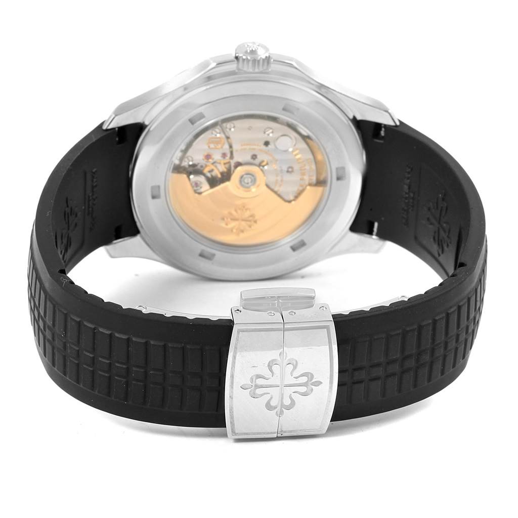 The image shows the back view of the Patek Philippe Aquanaut PATEK PHILIPPE Men's Stainless Steel Black Dial PATEK PHILIPPE Men's Stainless Steel Black Dial watch, highlighting its movement and black rubber strap with a clasp.