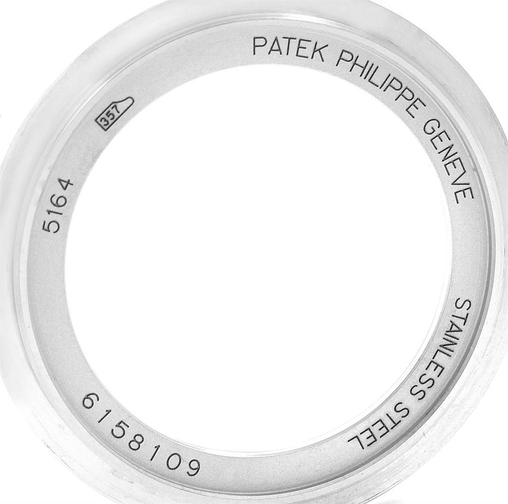 The image shows a stainless steel case back of a Patek Philippe Aquanaut 5164A Men's Stainless Steel Black Dial 5164A Men's Stainless Steel Black Dial watch, displaying model number 5164 and other engravings.