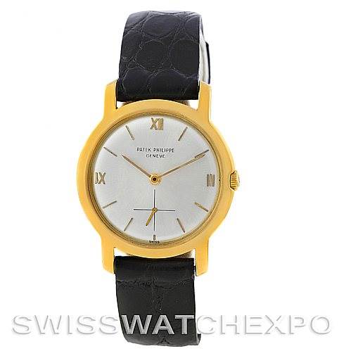 The image shows a front view of the Patek Philippe Vintage watch, displaying its round dial, gold case, and black leather strap.