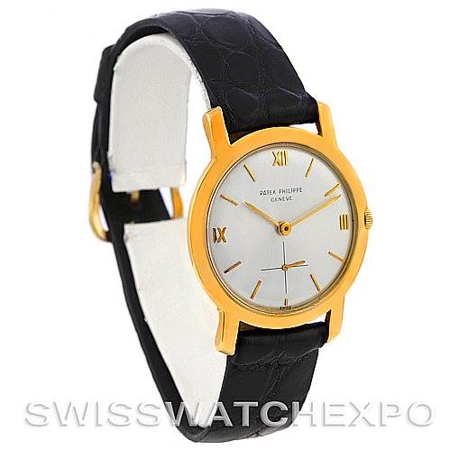 The image shows a side angle of a Vintage Patek Philippe watch, focusing on the face, gold casing, and black leather strap.