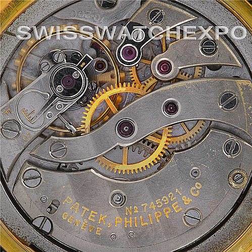 This image shows the intricate internal mechanical parts of a Vintage Patek Philippe watch, including gears and movement components.