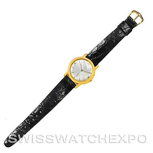 This image shows a top-down view of a Vintage Patek Philippe watch with a gold round case and black leather strap.