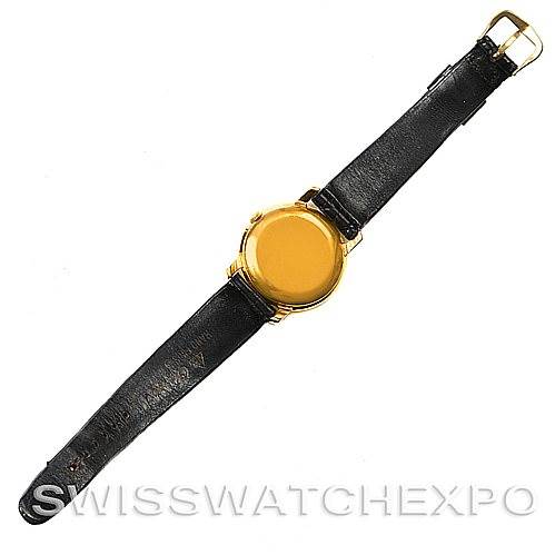 The image shows the back view of a Vintage Patek Philippe watch, capturing the gold case and black leather strap.