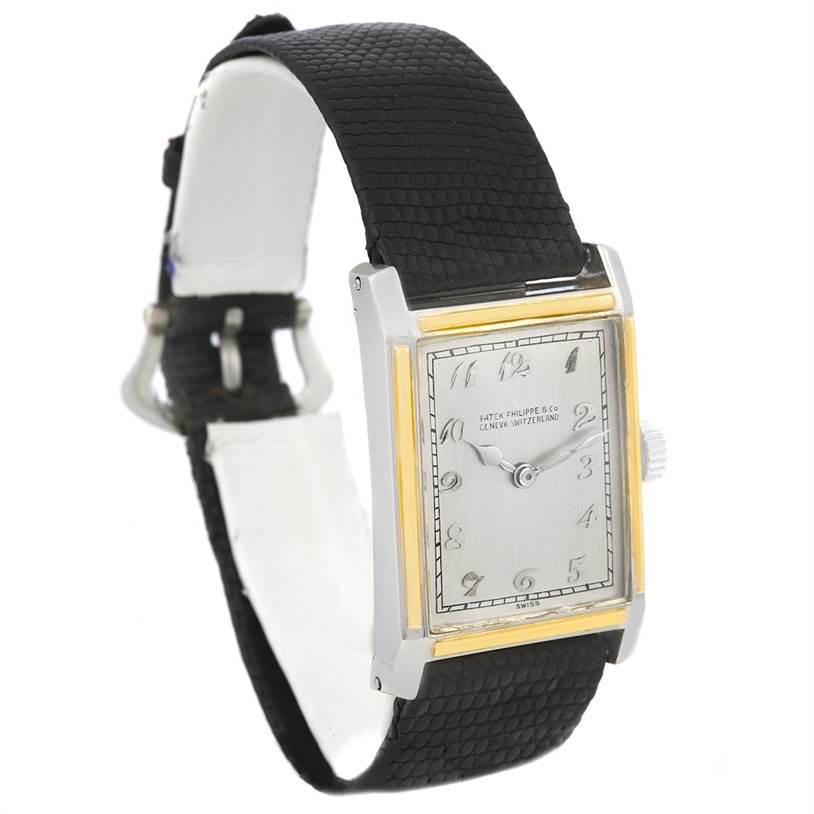 This image shows a side angle of a Vintage Patek Philippe watch, highlighting its rectangular face and black leather strap.