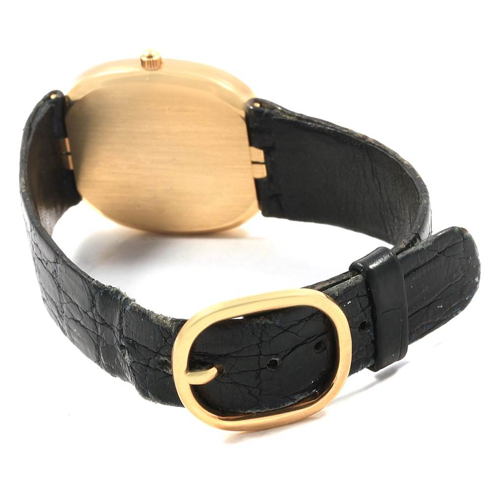 This image shows the back side of a Patek Philippe Golden Ellipse 3788 Men's Yellow Gold Blue Dial 3788 Men's Yellow Gold Blue Dial watch with a black strap and gold buckle.