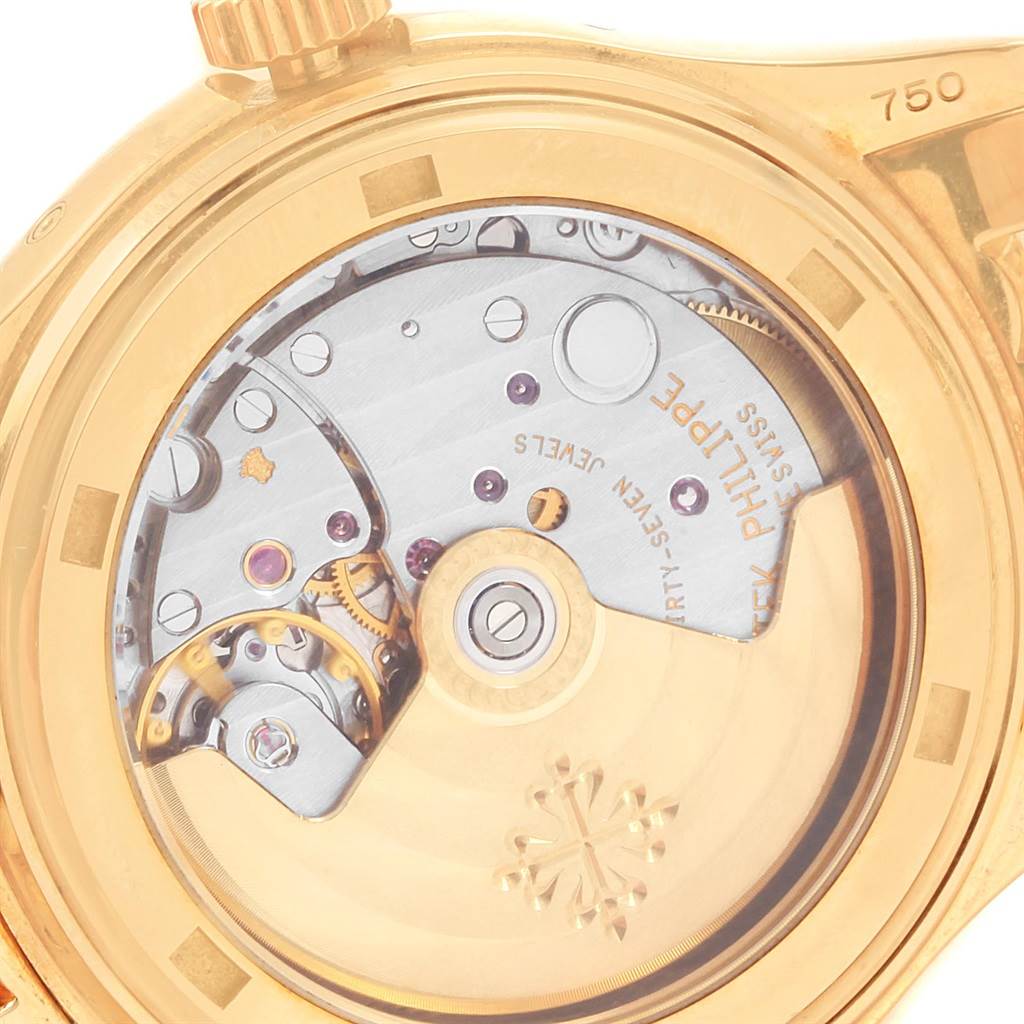 The angle displays the open case back of the Patek Philippe 5036 Men's Yellow Gold White Dial 5036 Men's Yellow Gold White Dial Annual Calendar Moonphase Yellow Gold Mens Watch 5036 model, revealing its movement.