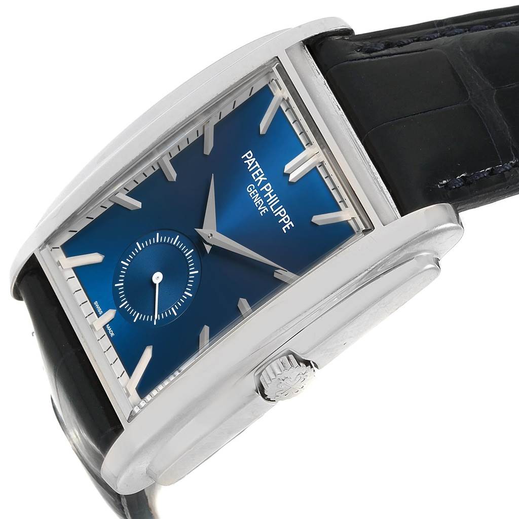 The image shows a side angle of the Patek Philippe Gondolo 5124G Men's White Gold Blue Dial 5124G Men's White Gold Blue Dial watch, highlighting its blue dial, crown, and black strap.