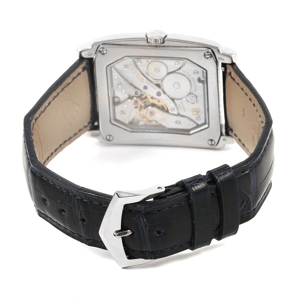 The image shows the back view of the Patek Philippe Gondolo 5124G Men's White Gold Blue Dial 5124G Men's White Gold Blue Dial watch, displaying its intricate movement and black leather strap.