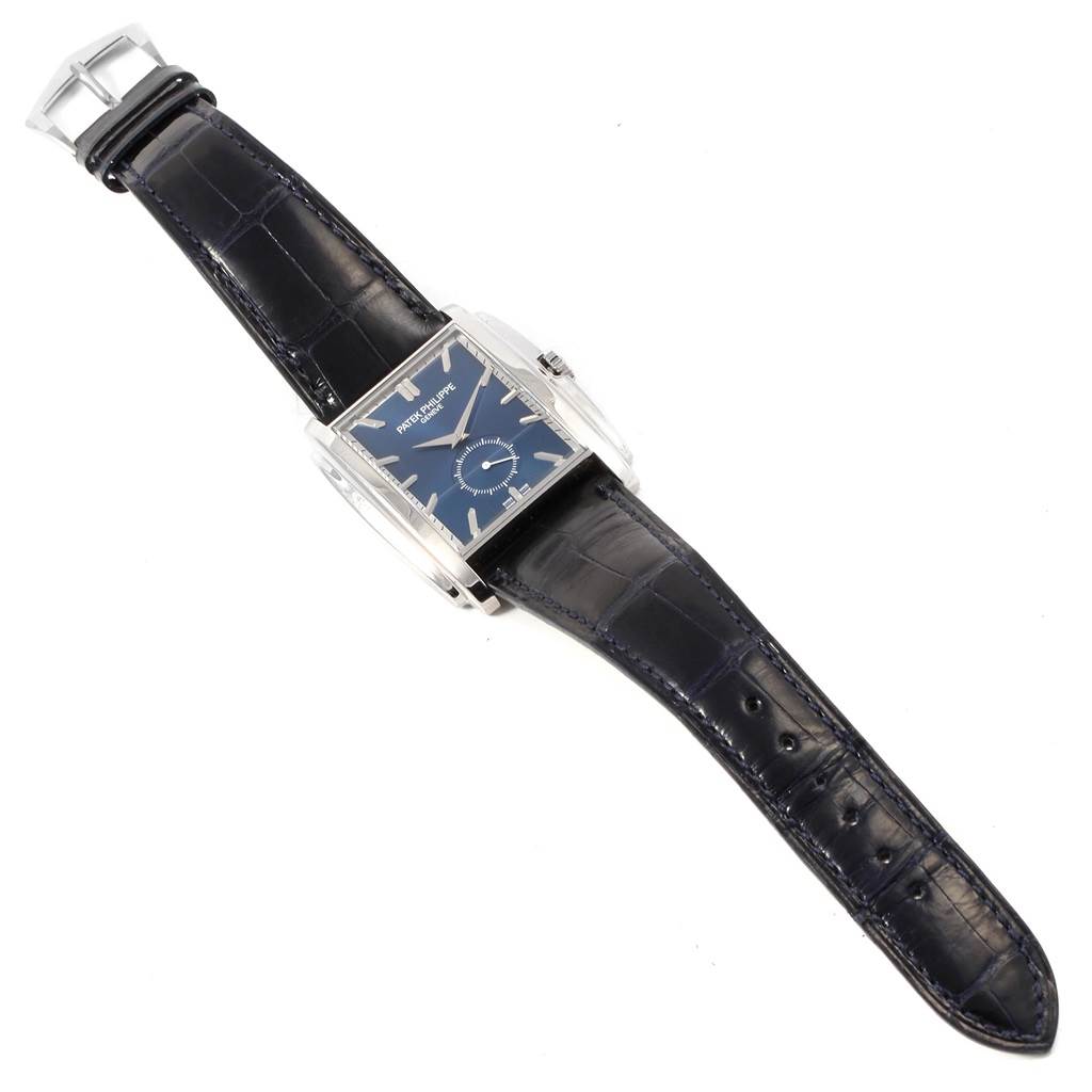 The image displays a top view of the Patek Philippe Gondolo 5124G Men's White Gold Blue Dial 5124G Men's White Gold Blue Dial watch, featuring a blue dial and black leather strap.