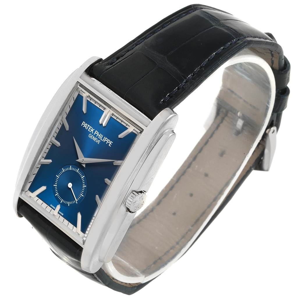 This image displays a Patek Philippe Gondolo 5124G Men's White Gold Blue Dial 5124G Men's White Gold Blue Dial watch at a slight side angle, showcasing the face, crown, and black leather strap.