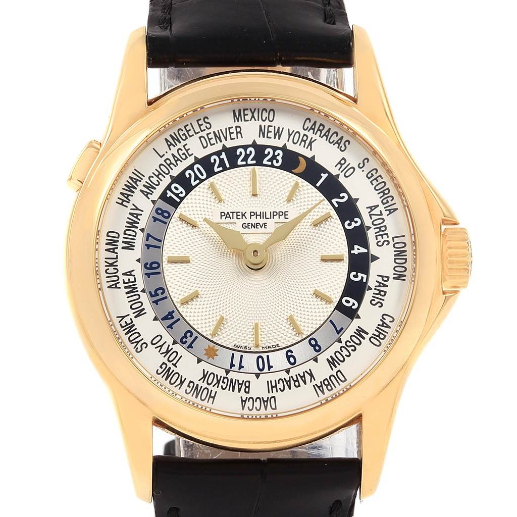 The image shows the front view of the Patek Philippe Complications 5110J Men
s Yellow Gold Silver Dial 5110J Men
s Yellow Gold Silver Dial watch, showcasing its world time dial and gold casing.