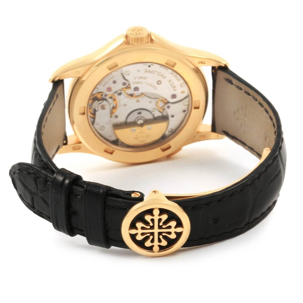 The image shows the back of a Patek Philippe Complications 5110J Men
s Yellow Gold Silver Dial 5110J Men
s Yellow Gold Silver Dial watch, highlighting the leather strap and clasp.