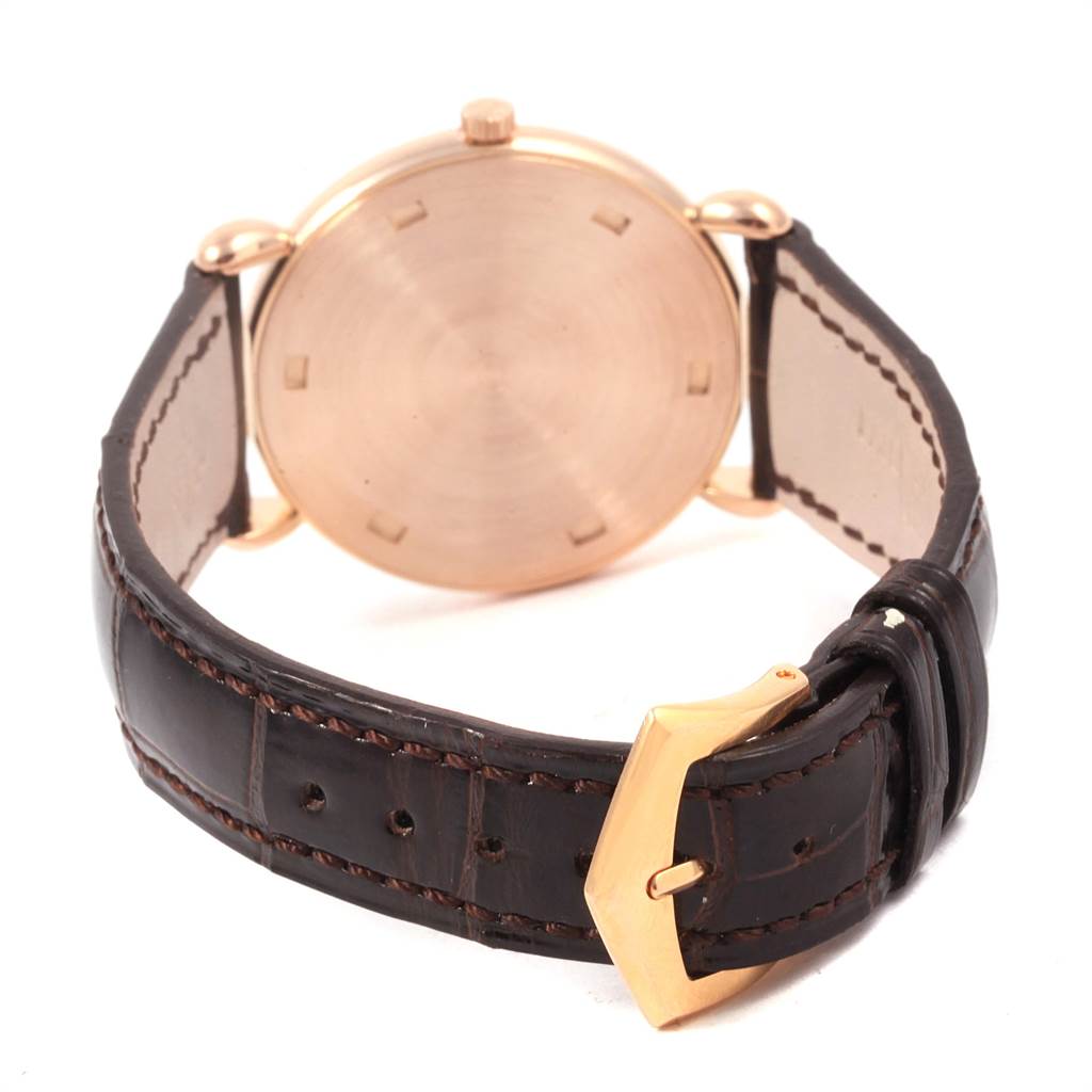 The image shows the back and clasp of a Vintage Patek Philippe watch with a brown leather strap and gold buckle.