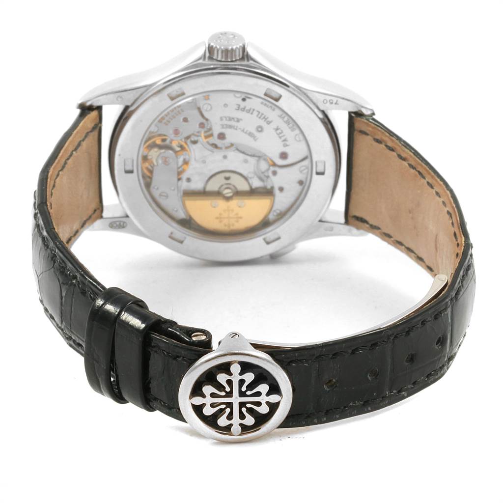 The image shows the back view of the Patek Philippe Complications 5110G Men
s White Gold Silver Dial 5110G Men
s White Gold Silver Dial model watch, highlighting its inner mechanisms and leather strap.