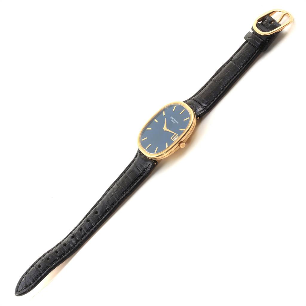 This image shows a top-down view of the Patek Philippe Golden Ellipse 3605 Men's Yellow Gold Blue Dial 3605 Men's Yellow Gold Blue Dial watch, displaying its face, strap, and buckle.