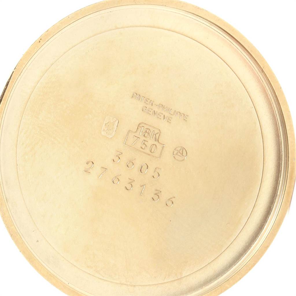 This image shows the inside case back of a Patek Philippe Golden Ellipse 3605 Men's Yellow Gold Blue Dial 3605 Men's Yellow Gold Blue Dial watch, highlighting engravings and hallmarks.