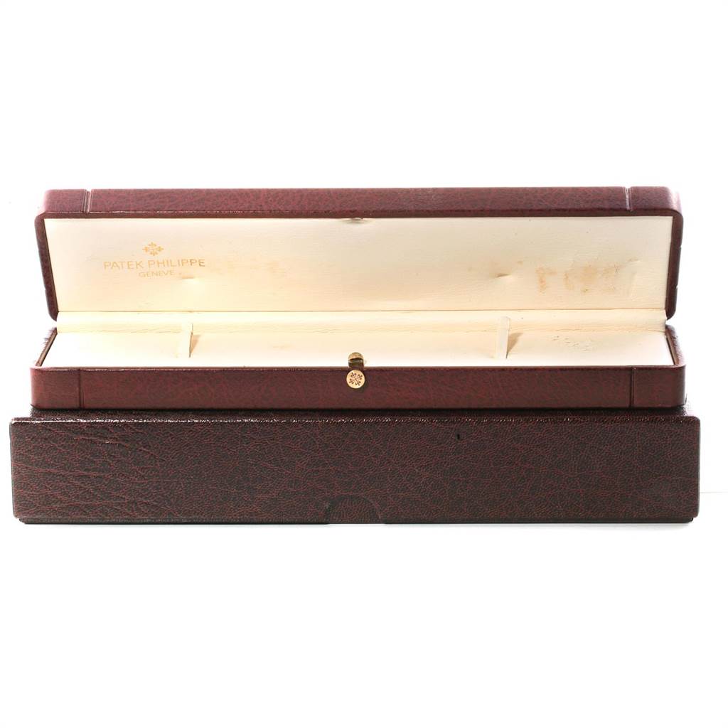 This image shows an open red watch box for the Patek Philippe Golden Ellipse 3605 Men's Yellow Gold Blue Dial 3605 Men's Yellow Gold Blue Dial model, displaying its interior compartments.