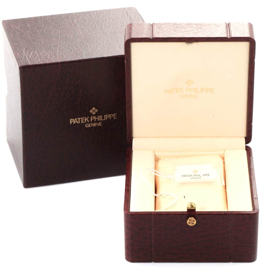 The image shows an open Patek Philippe Neptune 5085A/1A-001 Men's Stainless Steel Black Dial 5085A/1A-001 Men's Stainless Steel Black Dial model watch box, displaying the interior and a hangtag.