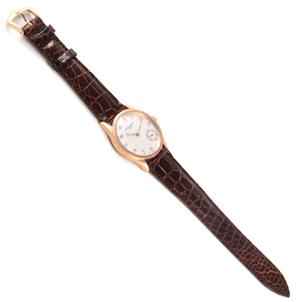 The Patek Philippe Calatrava 5026R Men
s Rose Gold Silver Dial 5026R Men
s Rose Gold Silver Dial watch is shown from the front, displaying the face, case, and brown leather strap.