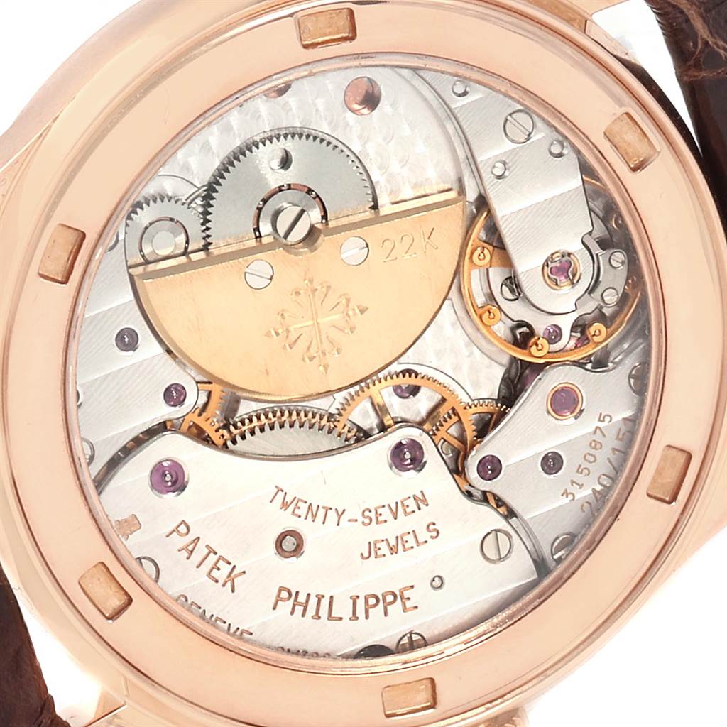 This is a close-up view of the movement of a Patek Philippe Calatrava 5026R Men
s Rose Gold Silver Dial 5026R Men
s Rose Gold Silver Dial watch, showcasing its intricate gears and jewels.