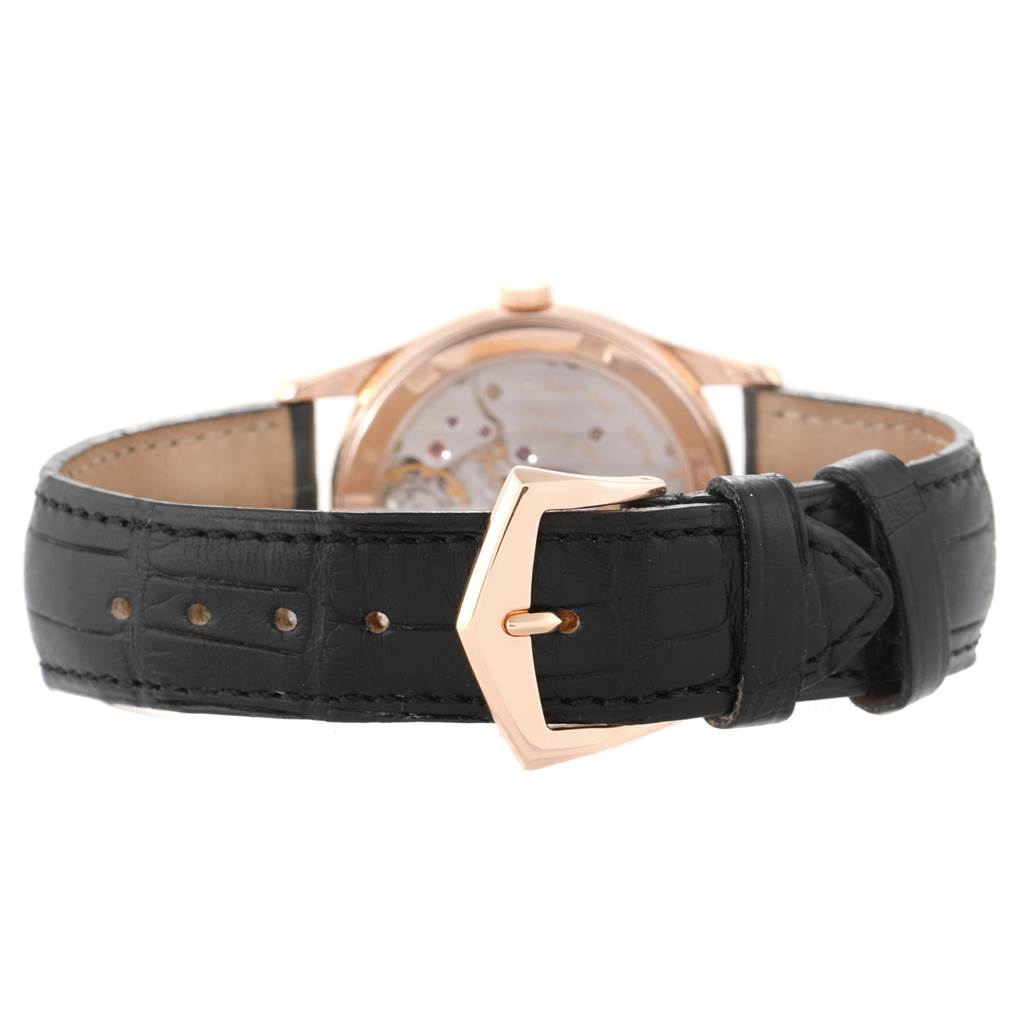 This image shows the back view of a Patek Philippe Calatrava 5026R Men's Rose Gold Black Dial 5026R Men's Rose Gold Black Dial watch with a leather strap and gold buckle.