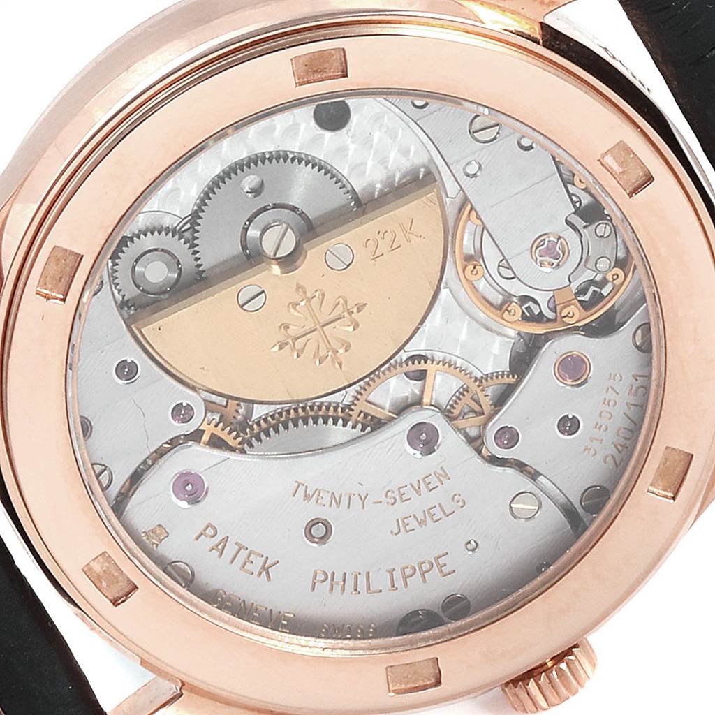 The image shows the backside of the Calatrava model by Patek Philippe, revealing its intricate mechanical movement and internal components.