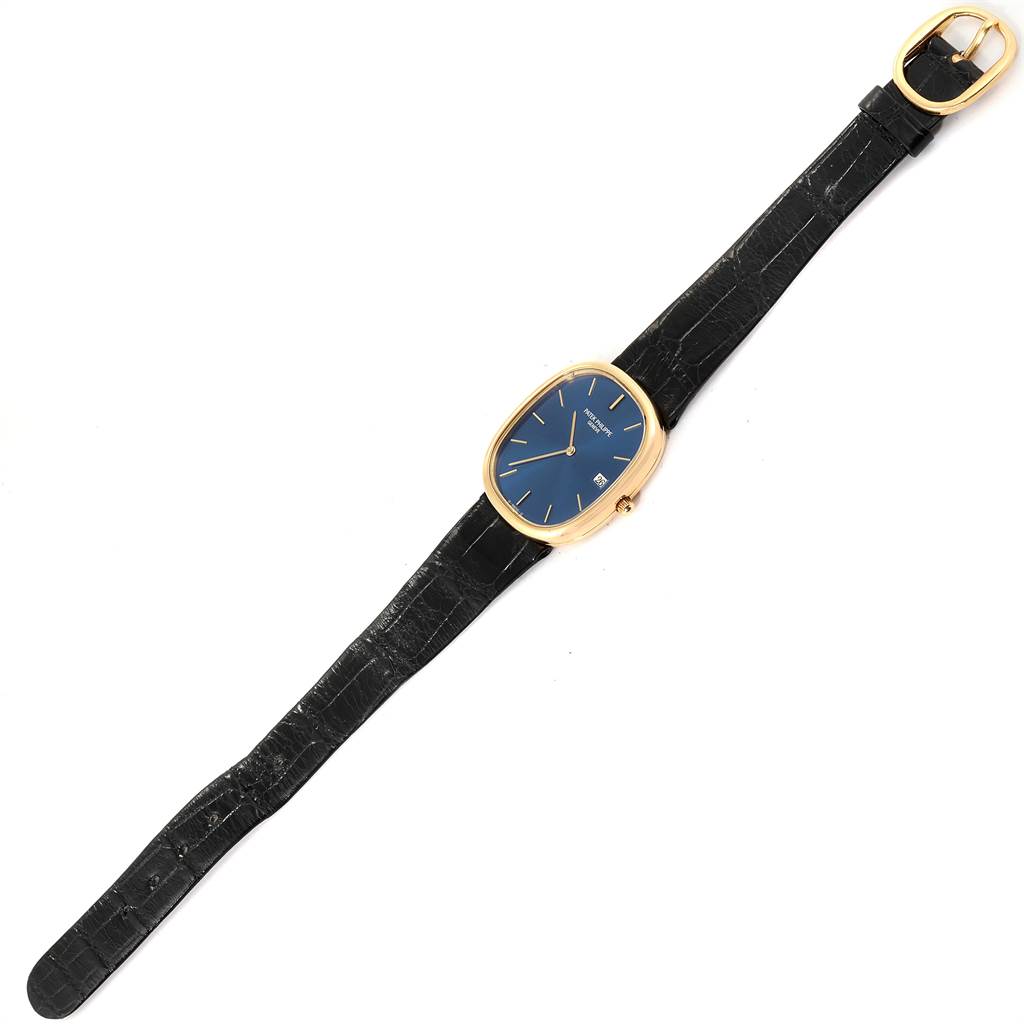 The image shows a full view of a Patek Philippe Golden Ellipse 3747 Men
s Yellow Gold Blue Dial 3747 Men
s Yellow Gold Blue Dial watch, including its blue dial, gold case, and black strap.