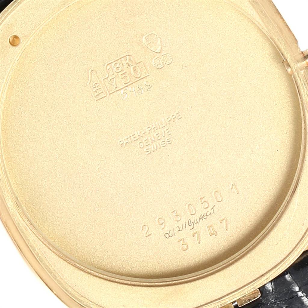 The image shows the inside of the case back of a Patek Philippe Golden Ellipse 3747 Men
s Yellow Gold Blue Dial 3747 Men
s Yellow Gold Blue Dial watch, highlighting the engravings and hallmarks.
