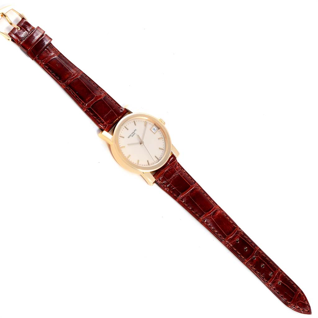 The image shows a full, top-down view of the Patek Philippe Calatrava 5012 Men's Yellow Gold Beige Dial 5012 Men's Yellow Gold Beige Dial watch, including its face and brown leather strap.