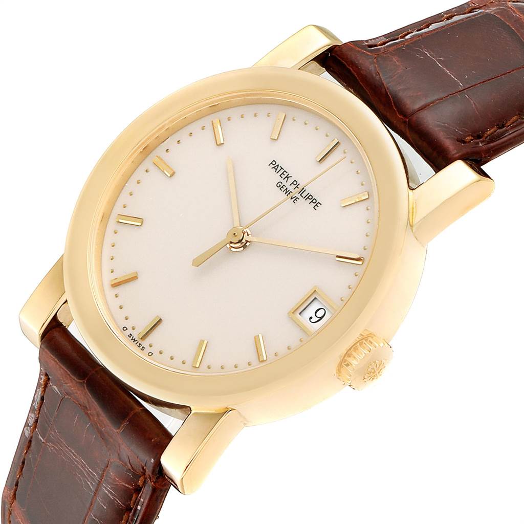 The image shows a Patek Philippe Calatrava 5012 Men's Yellow Gold Beige Dial 5012 Men's Yellow Gold Beige Dial watch from a front angle, revealing the dial, case, crown, and part of the leather strap.