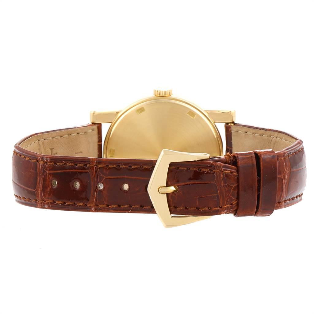 The image shows the rear view and leather strap of a Patek Philippe Calatrava 5012 Men's Yellow Gold Beige Dial 5012 Men's Yellow Gold Beige Dial watch, highlighting its gold case and buckle.