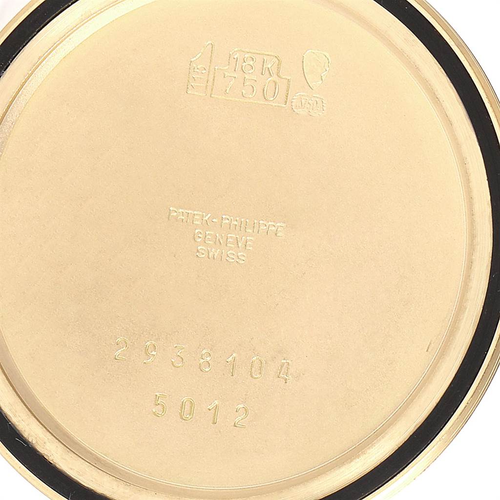 This image shows the inner case back of a Patek Philippe Calatrava 5012 Men's Yellow Gold Beige Dial 5012 Men's Yellow Gold Beige Dial model, including hallmarks and engravings.