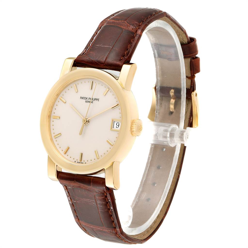 The image shows a side and front view of the Patek Philippe Calatrava 5012 Men's Yellow Gold Beige Dial 5012 Men's Yellow Gold Beige Dial watch, highlighting the face, crown, and leather strap.