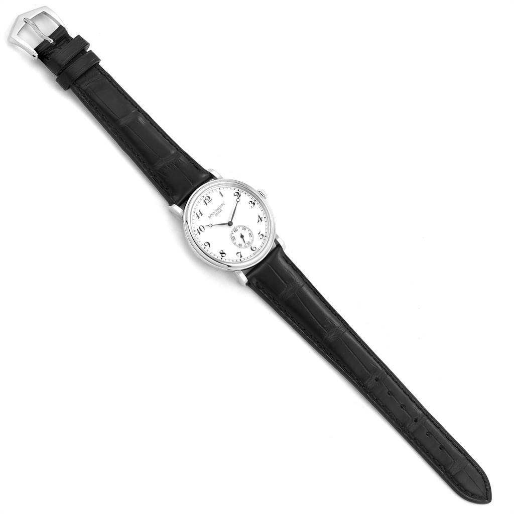 The image shows a Patek Philippe Calatrava 5022P Men's Platinum White Dial 5022P Men's Platinum White Dial watch from a top-down angle, featuring its face, black leather strap, and silver buckle.