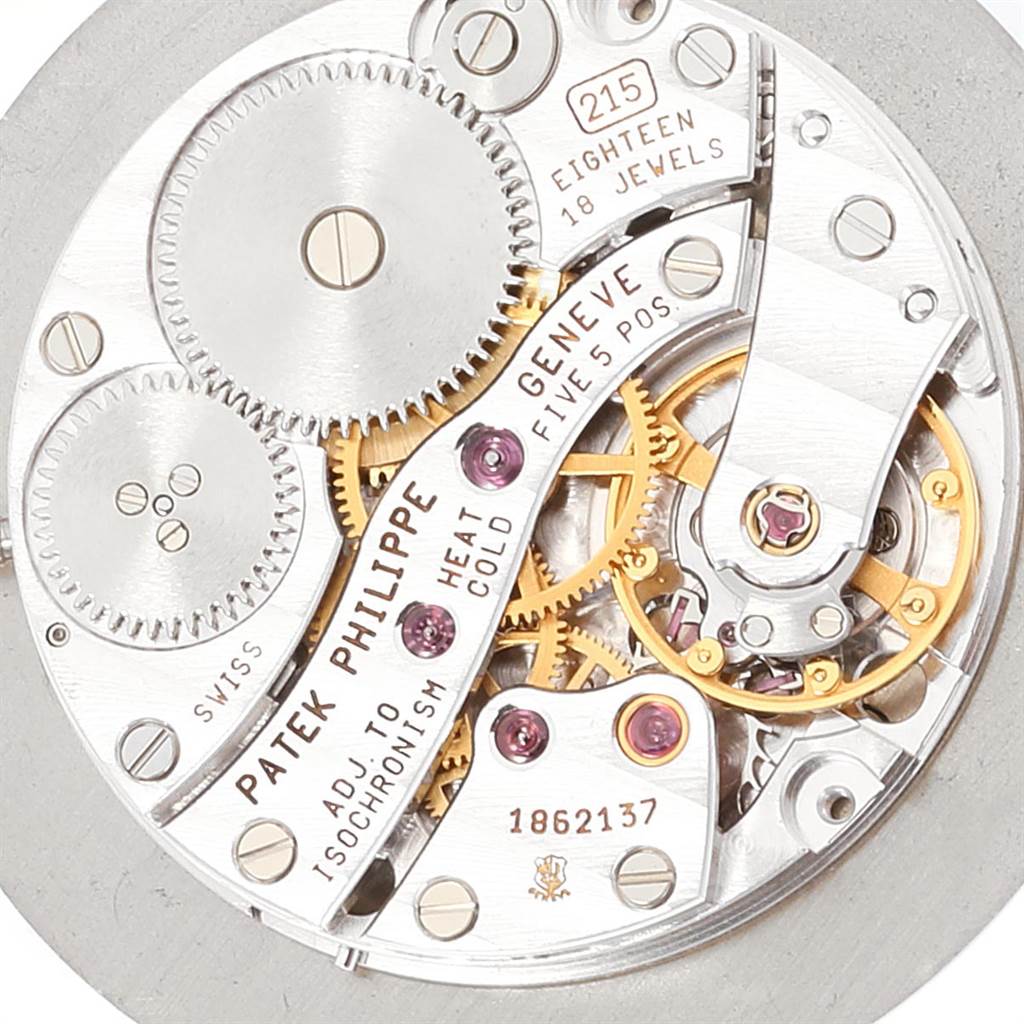 This image shows a close-up of the movement mechanism in a Patek Philippe Calatrava 5022P Men's Platinum White Dial 5022P Men's Platinum White Dial watch, displaying its intricate gears and jewels.