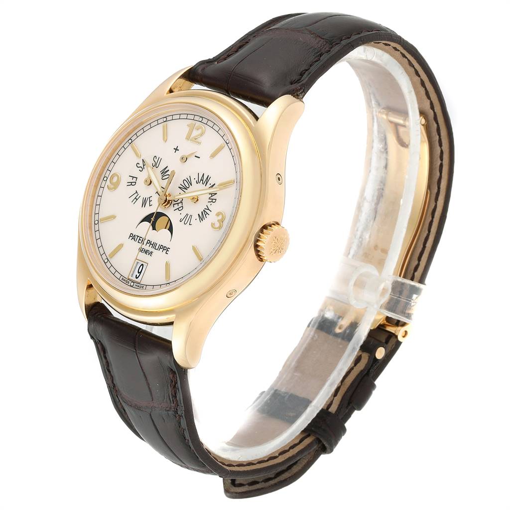 The Patek Philippe 5146J Men
s Yellow Gold Beige Dial 5146J Men
s Yellow Gold Beige Dial Complicated Annual Calendar 5146J model is shown at a three-quarter angle, highlighting the yellow gold case and leather strap.