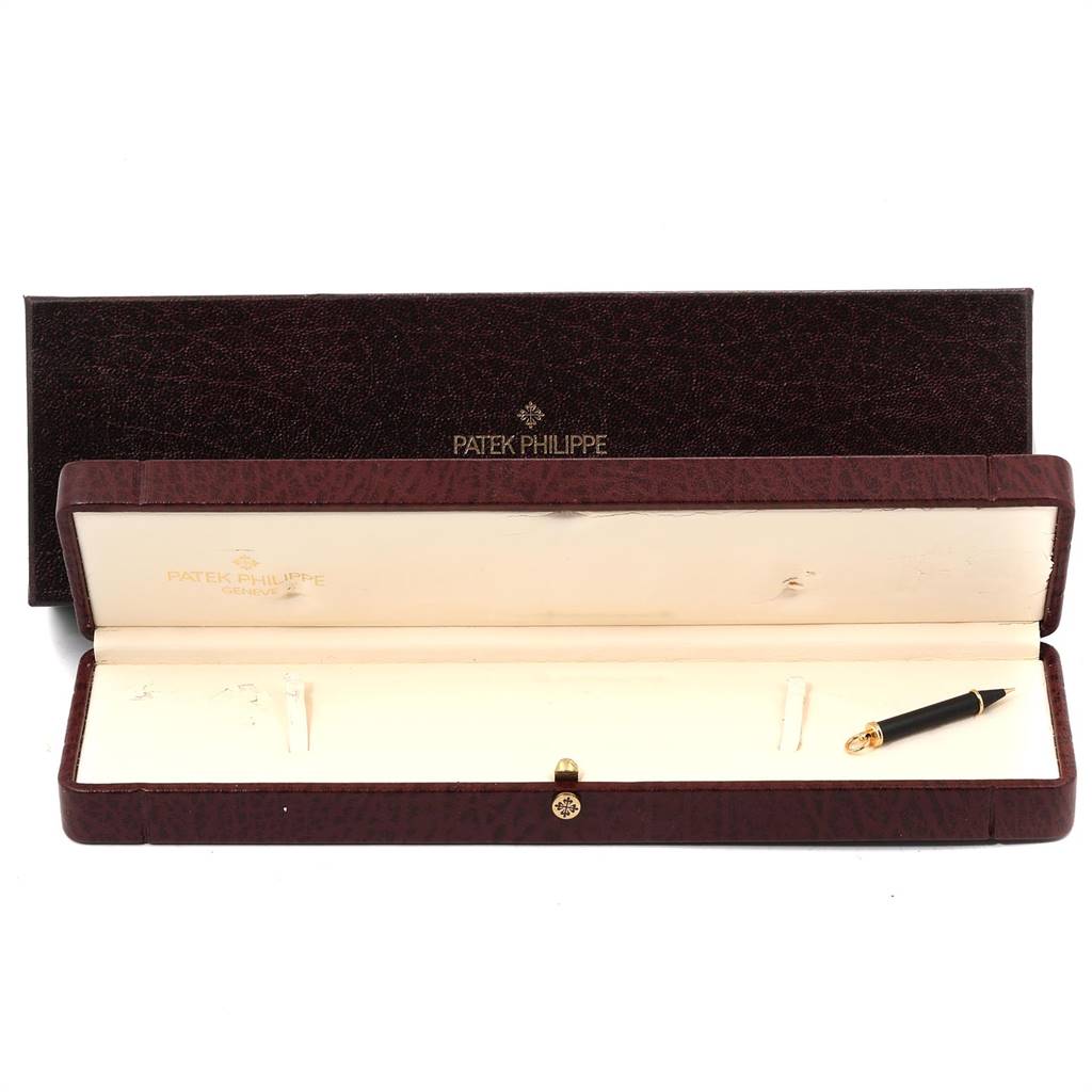 The image shows the open box and pen accessory of the Patek Philippe 5146J Men
s Yellow Gold Beige Dial 5146J Men
s Yellow Gold Beige Dial Complicated Annual Calendar Yellow Gold Men
s Watch 5146J model.