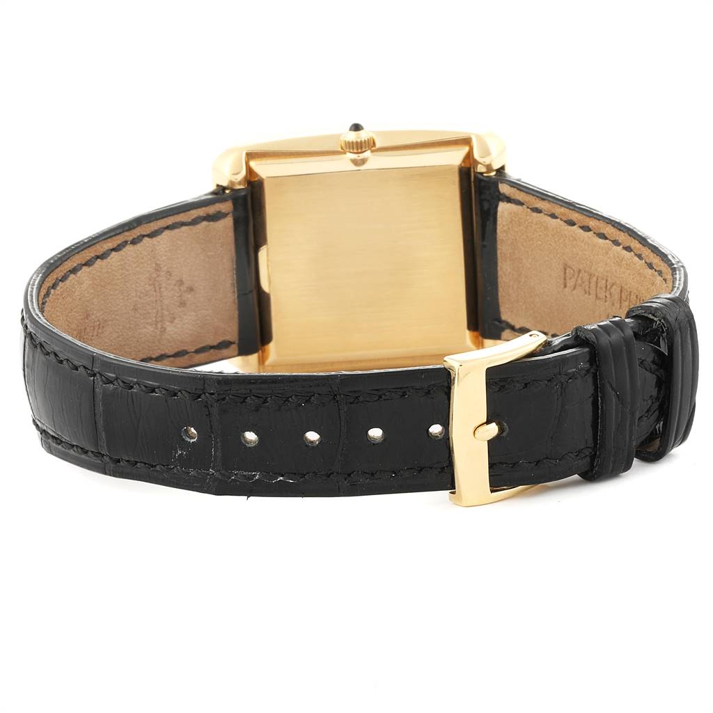 The image shows the back of a Patek Philippe Vintage 3633 Men's Yellow Gold Black Dial 3633 Men's Yellow Gold Black Dial watch with a black strap and gold buckle.