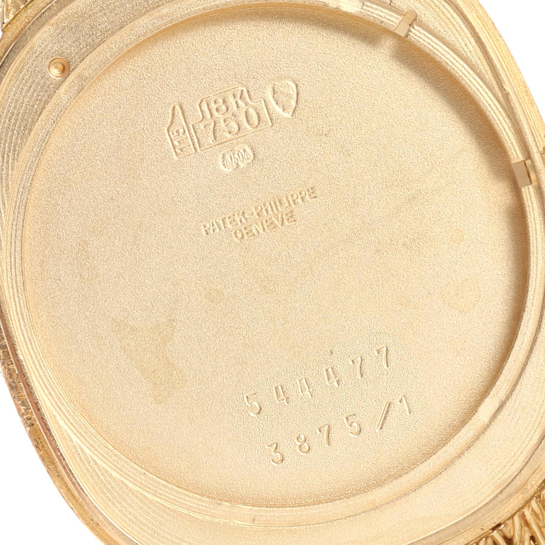 This image shows the interior case back of a Patek Philippe Golden Ellipse 3875 Men's Yellow Gold Blue Dial 3875 Men's Yellow Gold Blue Dial watch, displaying its engravings and markings.