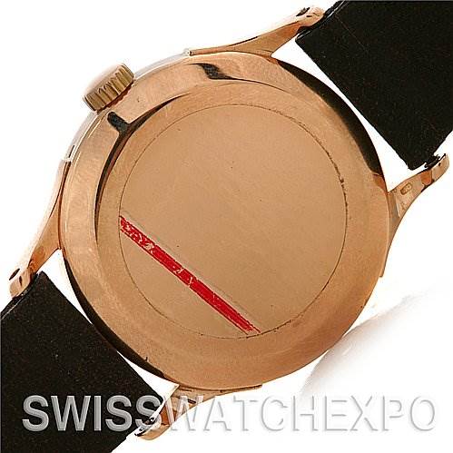 The image shows the back case of a Vintage Patek Philippe watch from a rear angle, displaying its rose gold finish and part of the black strap.