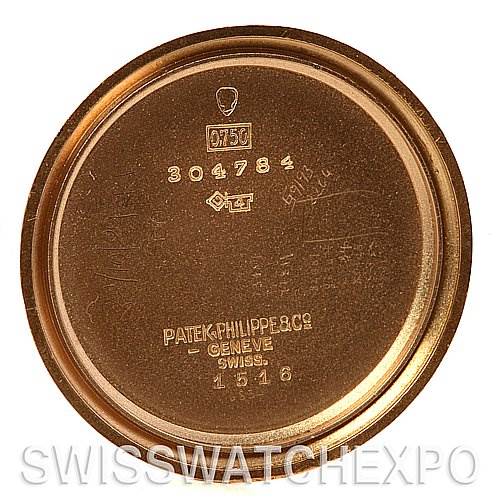 This image shows the inner caseback of a vintage Patek Philippe watch, model 1518, with various inscriptions and hallmarks.