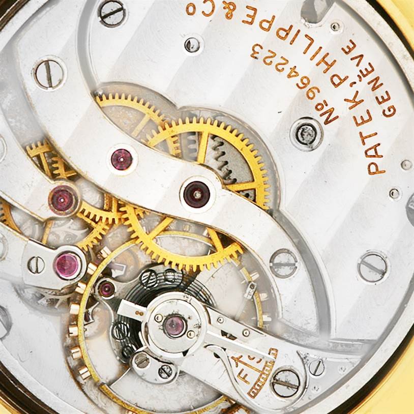 This image shows the intricate movement and internal mechanisms of a vintage Patek Philippe watch.