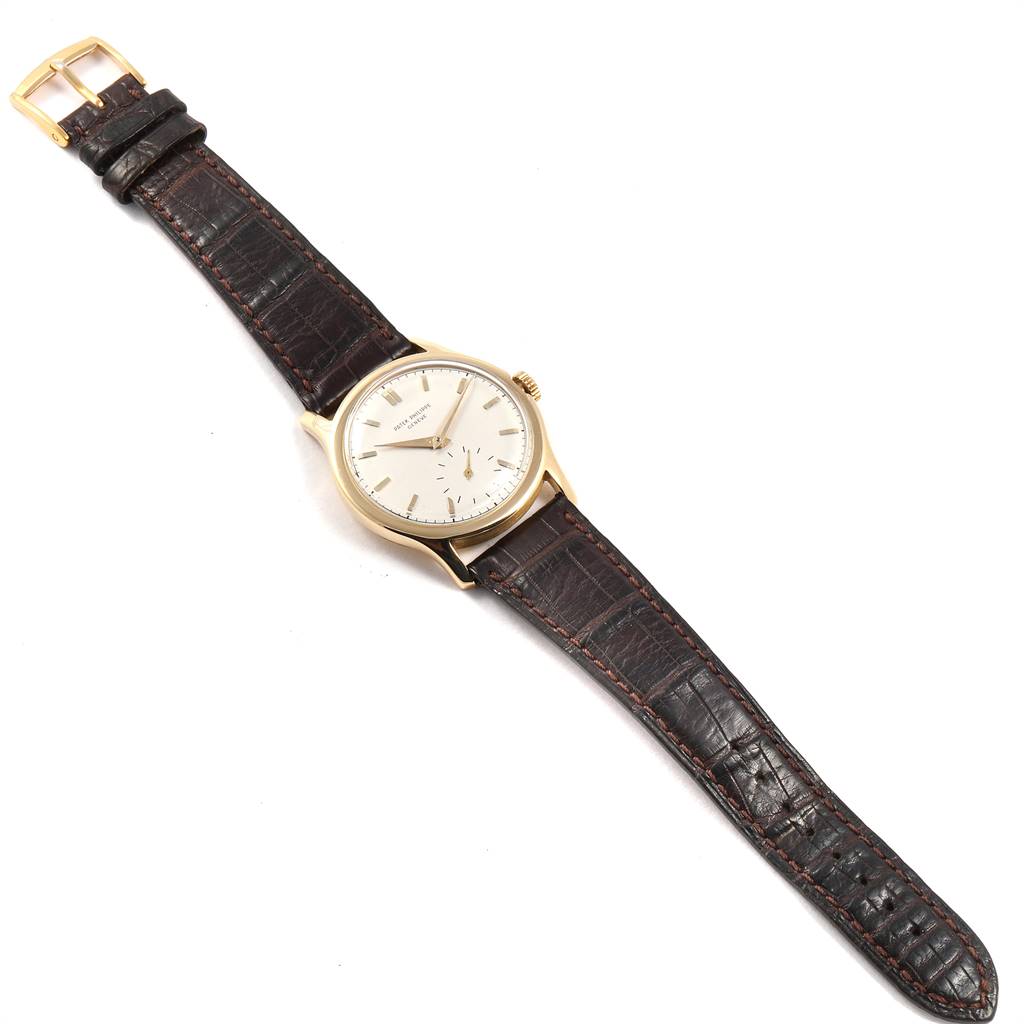 This image shows the Vintage Patek Philippe watch from a top-down angle, displaying its dial, case, and leather strap.